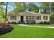 Charming single-story home featuring a well-manicured lawn, a stone walkway, and a classic, welcoming facade at 960 Lindridge Ne Dr, Atlanta, GA 30324