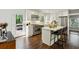 Modern kitchen with stainless steel appliances, a kitchen island with seating, and white cabinets at 960 Lindridge Ne Dr, Atlanta, GA 30324