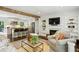 Bright living room featuring a fireplace, open shelving, and a view of the adjacent kitchen at 960 Lindridge Ne Dr, Atlanta, GA 30324