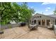 Large wooden deck with outdoor seating, a grill, and beautiful views of the treed backyard at 97 Peachtree Hills Ne Ave, Atlanta, GA 30305