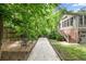 Beautiful backyard featuring a bocce court, mature trees and a patio area with seating at 97 Peachtree Hills Ne Ave, Atlanta, GA 30305
