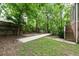 This backyard offers a bocce court and patio area surrounded by mature trees and lush greenery at 97 Peachtree Hills Ne Ave, Atlanta, GA 30305
