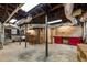 Spacious basement featuring open ceilings, red cabinets, and concrete floors at 97 Peachtree Hills Ne Ave, Atlanta, GA 30305