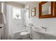 Cozy bathroom featuring white tile, updated fixtures, and a shower/tub combo at 97 Peachtree Hills Ne Ave, Atlanta, GA 30305
