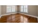 Neutral bedroom with hardwood floors and two windows with white shutters at 97 Peachtree Hills Ne Ave, Atlanta, GA 30305