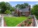 Charming brick home with a manicured lawn, white picket fence, and beautiful landscaping at 97 Peachtree Hills Ne Ave, Atlanta, GA 30305