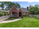 Charming brick Tudor home features a covered porch and a lush, well-manicured front lawn at 97 Peachtree Hills Ne Ave, Atlanta, GA 30305