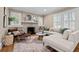 Bright living room features hardwood floors, fireplace, built-in shelving, and plantation shutters at 97 Peachtree Hills Ne Ave, Atlanta, GA 30305