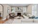 Cozy living room with neutral décor, a fireplace, hardwood floors, and large windows at 97 Peachtree Hills Ne Ave, Atlanta, GA 30305