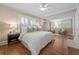 Spacious main bedroom with hardwood floors, large windows, ceiling fan, and ensuite sitting area at 97 Peachtree Hills Ne Ave, Atlanta, GA 30305