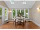 Bright sunroom with table, chairs, wall sconces, and lots of windows at 97 Peachtree Hills Ne Ave, Atlanta, GA 30305