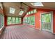 Bright sunroom with plenty of windows, a ceiling fan, and a wooden floor at 97 Peachtree Hills Ne Ave, Atlanta, GA 30305