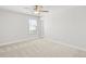 Bedroom with neutral carpet, ceiling fan, and a window at 205 Kindness Cir, Mcdonough, GA 30252