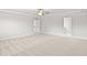 Spacious bedroom featuring neutral carpet, white walls, and a ceiling fan for a clean, modern aesthetic at 205 Kindness Cir, Mcdonough, GA 30252