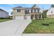 Two-story brick home with a three-car garage, green lawn and concrete driveway at 205 Kindness Cir, Mcdonough, GA 30252
