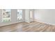 Flex space with light wood floors, two large windows and a door to the exterior at 205 Kindness Cir, Mcdonough, GA 30252