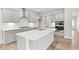 Modern kitchen with an island, stainless steel appliances, and light gray cabinets at 205 Kindness Cir, Mcdonough, GA 30252