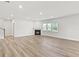 Open living room with light wood floors, fireplace, and lots of natural light at 205 Kindness Cir, Mcdonough, GA 30252
