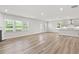 Open living area with fireplace and light wood floors leading to the kitchen at 205 Kindness Cir, Mcdonough, GA 30252