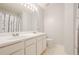 Bright bathroom featuring double sinks, white cabinets, and a large mirror with vanity lighting at 3746 Berkeley Xing, Duluth, GA 30096