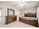 Bedroom features a large bed, dark wood furniture, and a mirror at 3746 Berkeley Xing, Duluth, GA 30096