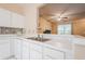 Another angle of kitchen featuring open concept to living area at 3746 Berkeley Xing, Duluth, GA 30096