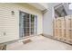 View of the outdoor patio with sliding glass doors and a wooden fence providing backyard privacy at 3746 Berkeley Xing, Duluth, GA 30096