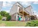 Exterior view of the home's back featuring a wooden deck, lawn, and siding at 6080 Indian Wood Se Cir, Mableton, GA 30126
