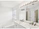 Clean bathroom with double sinks, a bathtub, and a large mirror, creating a refreshing and modern space at 6080 Indian Wood Se Cir, Mableton, GA 30126