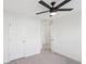 Clean bedroom offering a ceiling fan, plush carpeting, and a closet for easy storage at 6080 Indian Wood Se Cir, Mableton, GA 30126