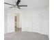 Spacious bedroom featuring a ceiling fan, neutral walls, and plush carpeting at 6080 Indian Wood Se Cir, Mableton, GA 30126