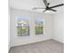 Bright bedroom with two windows that provide ample natural light, ceiling fan, and plush carpeting at 6080 Indian Wood Se Cir, Mableton, GA 30126