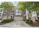 Charming brick townhome with a two-car garage, covered entrance, and lush landscaping creating a welcoming curb appeal at 6080 Indian Wood Se Cir, Mableton, GA 30126