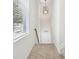 Bright carpeted hallway with a stylish pendant light, and a view of the entryway at 6080 Indian Wood Se Cir, Mableton, GA 30126
