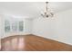 Open living room featuring hardwood floors, chandelier, and bay windows at 6080 Indian Wood Se Cir, Mableton, GA 30126