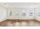 Open living room featuring hardwood floors and natural light from three windows at 6080 Indian Wood Se Cir, Mableton, GA 30126