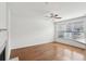 Open living room features a fireplace, hardwood floors, and natural light from the window at 6080 Indian Wood Se Cir, Mableton, GA 30126