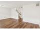 Open living room featuring wood floors, stairwell access, and natural light at 6080 Indian Wood Se Cir, Mableton, GA 30126