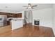 Cozy living area featuring hardwood floors, a fireplace, and a breakfast bar overlooking the stainless steel appliances in the kitchen at 6080 Indian Wood Se Cir, Mableton, GA 30126