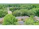 An aerial view showcases well maintained townhouses amongst a lush forest of trees at 70 Old Ivy Ne Rd # 29, Atlanta, GA 30342