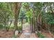 Lush backyard garden with stone pathway and a metal gate creating a serene retreat at 70 Old Ivy Ne Rd # 29, Atlanta, GA 30342