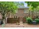 A charming brick townhouse boasts a private backyard and gated brick privacy wall, perfect for relaxing outdoors at 70 Old Ivy Ne Rd # 29, Atlanta, GA 30342