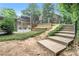 Stairway leading to a private fenced backyard pool and lush landscaping at 70 Old Ivy Ne Rd # 29, Atlanta, GA 30342