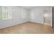 A bedroom showcasing neutral walls, hardwood floors, and a view into the hallway at 70 Old Ivy Ne Rd # 29, Atlanta, GA 30342