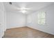 This bedroom features hardwood floors, two windows with plantation shutters and a ceiling fan at 70 Old Ivy Ne Rd # 29, Atlanta, GA 30342