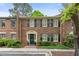 Charming brick townhome with dark green shutters and well-maintained landscaping at 70 Old Ivy Ne Rd # 29, Atlanta, GA 30342