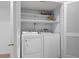 Convenient laundry room with a washer and dryer and open shelving at 70 Old Ivy Ne Rd # 29, Atlanta, GA 30342