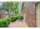 Cozy brick patio with black metal table and chairs, surrounded by manicured greenery at 70 Old Ivy Ne Rd # 29, Atlanta, GA 30342