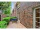 Private brick patio with dining area, surrounded by brick wall, fence and mature landscaping at 70 Old Ivy Ne Rd # 29, Atlanta, GA 30342