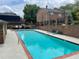 Community pool surrounded by brick walls and greenery offering a refreshing oasis at 70 Old Ivy Ne Rd # 29, Atlanta, GA 30342
